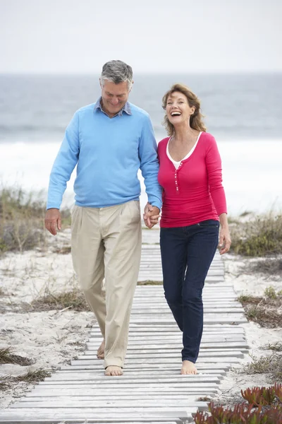 Senior couple walking by sea