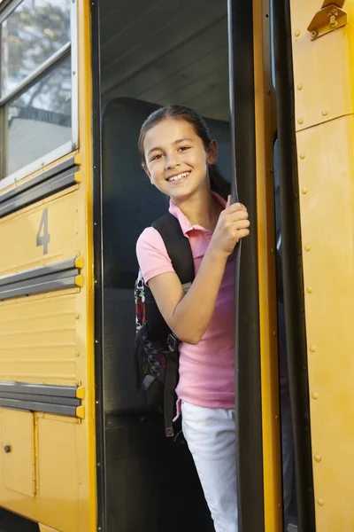 Girl getting on school bus