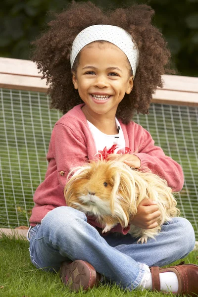 Young girl  holding guinea pig