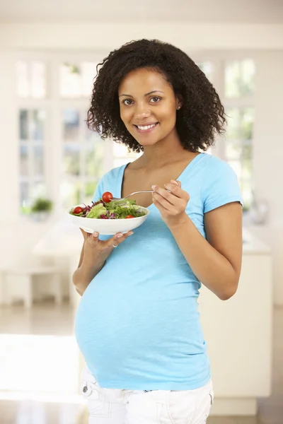 Pregnant woman with salad