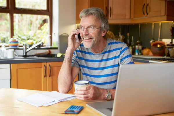 Mature Man  Looking At Home Finances