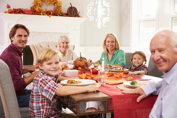 Family Enjoying Thanksgiving Meal At Table