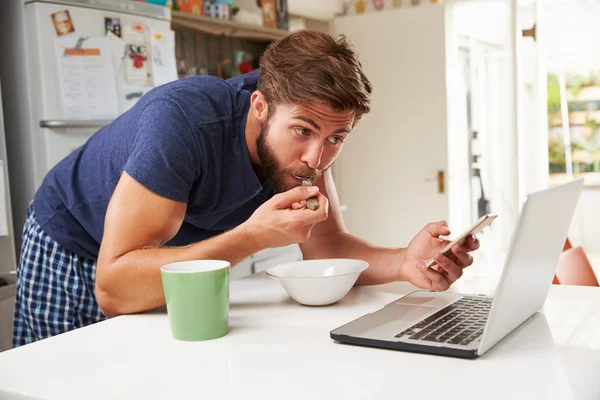Man Eating Breakfast With Devices