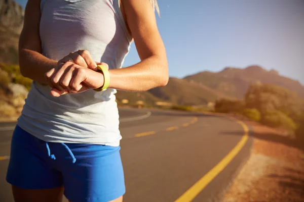 Woman checking her sports watch