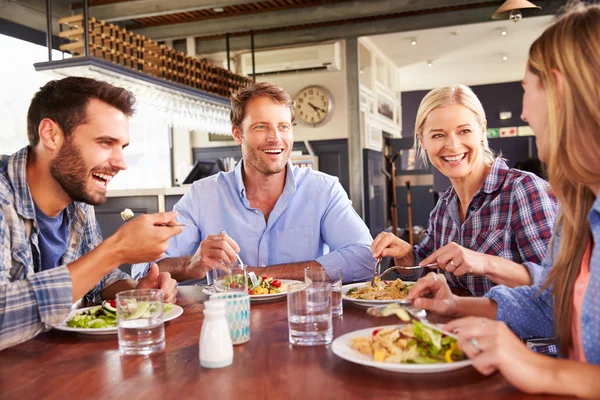 A group of friends eating at a restaurant