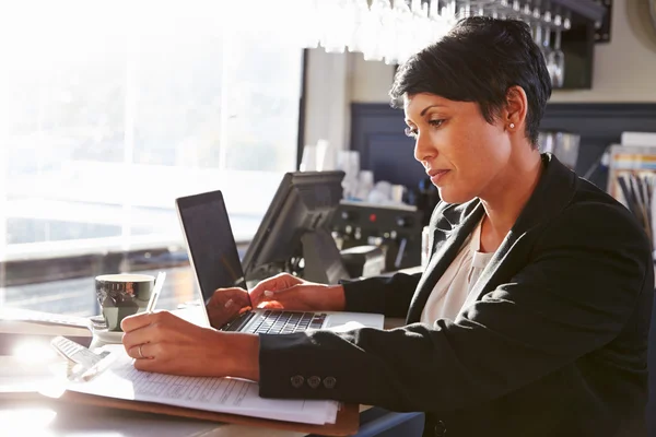 Restaurant manager working at counter