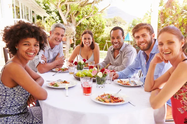 Friends dining together in a garden