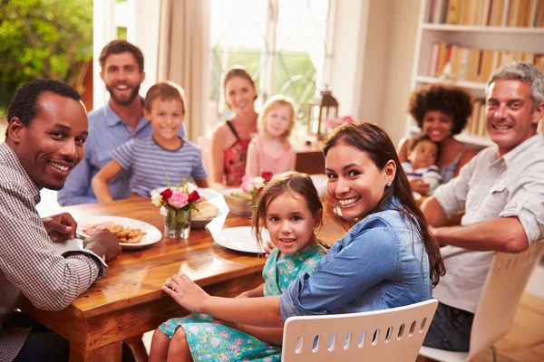 Family and friends sitting at a dining table