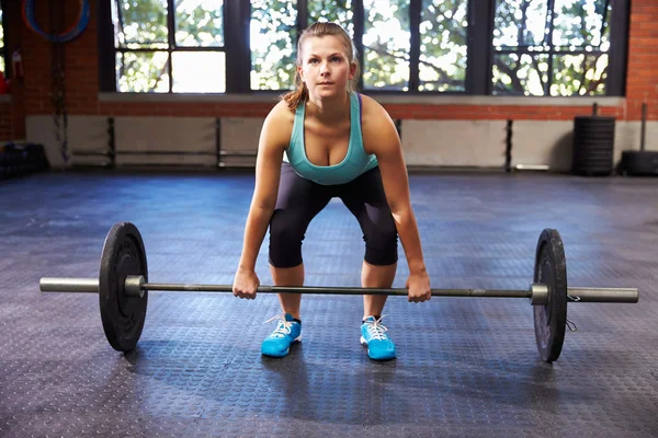 Woman Preparing To Lift Weights