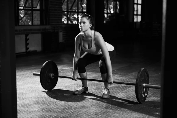 Woman Preparing To Lift Weights