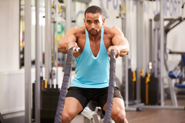 Man prepares for work out at a gym