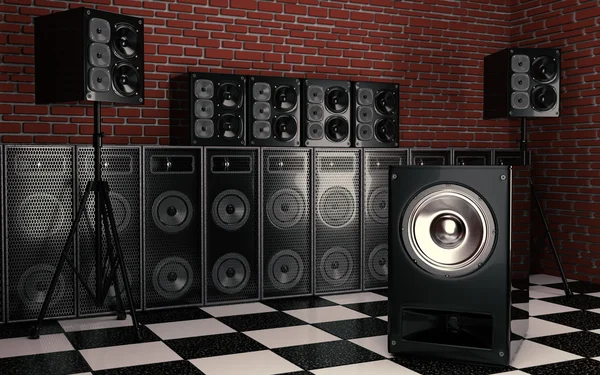Black audio speakers on checkered floor underground studio