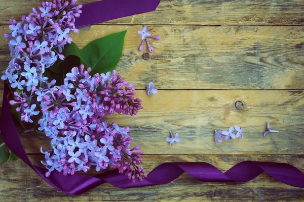 Bouquet of lilac branches with purple ribbon