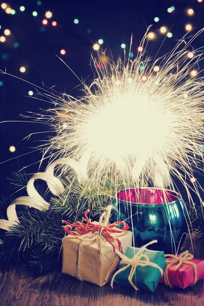 Christmas background with sparkler and gifts