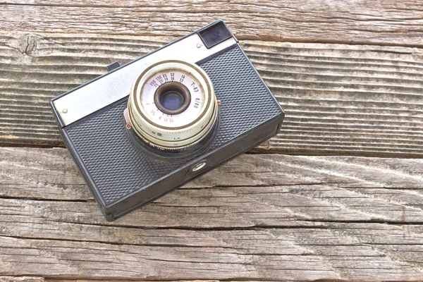 Vintage film photo camera on wooden background