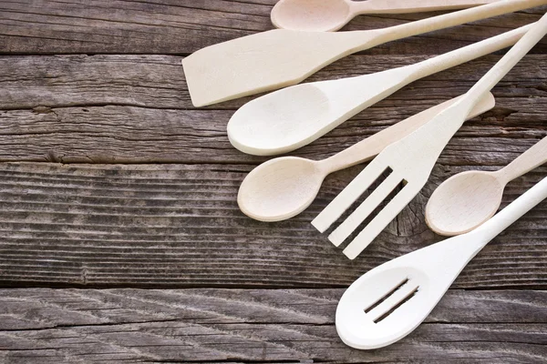 Wooden cutlery set on wooden background