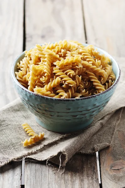 Integral raw pasta fusilli on the table