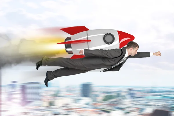 Businessman flying with rocket