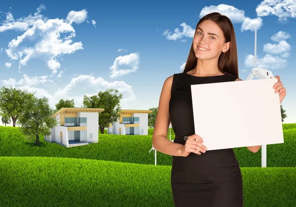 Businesswoman with landscape and houses