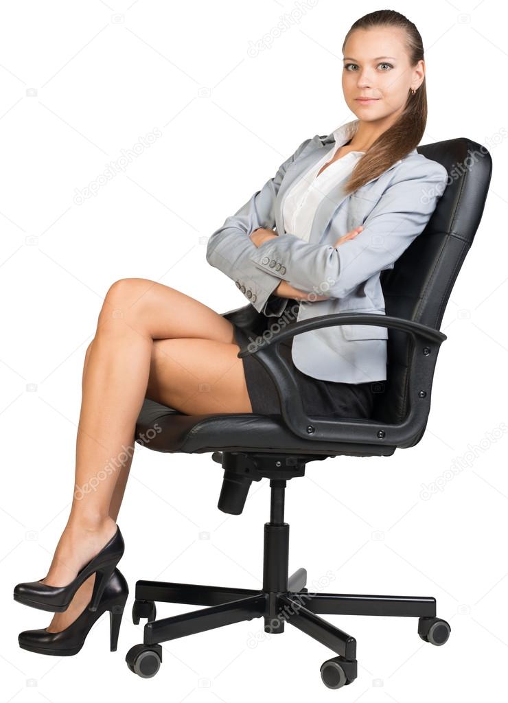 Businesswoman in office chair with straight back and crossed legs