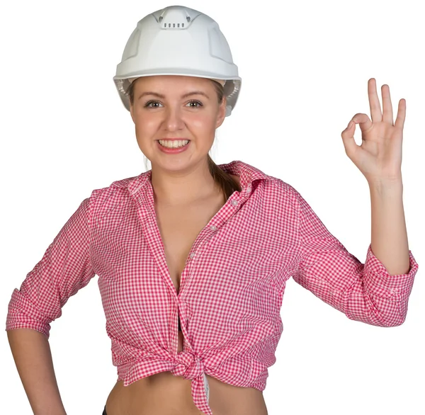 Woman in hard hat making okay gesture