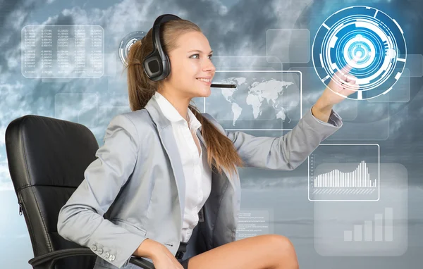 Businesswoman in headset using virtual interface