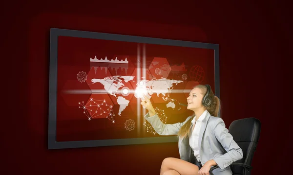 Businesswoman in headset using touch screen interface