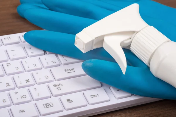 Airbrush with rubber gloves on keyboard