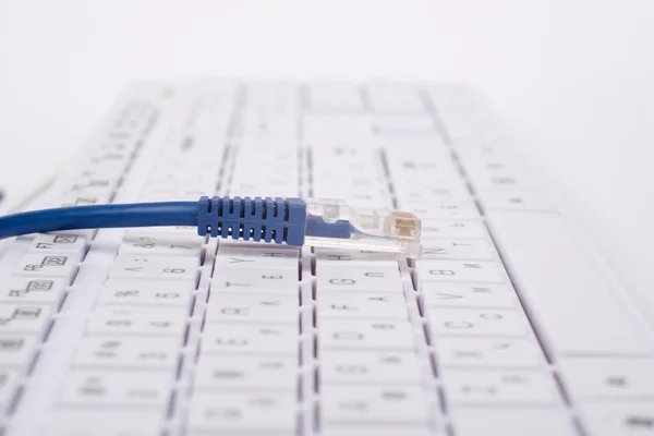 Blue computer cable on keyboard