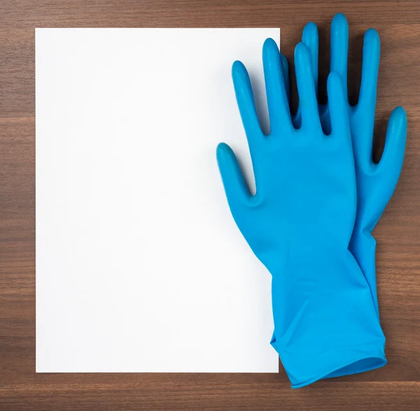 Blank paper with blue rubber gloves