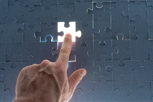 Missing jigsaw puzzle piece with light glow