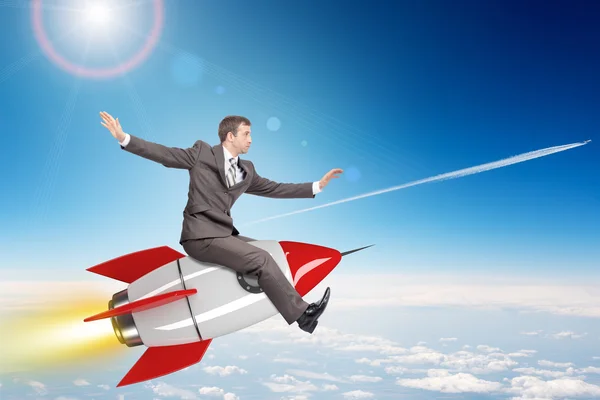 Businessman flying on rocket