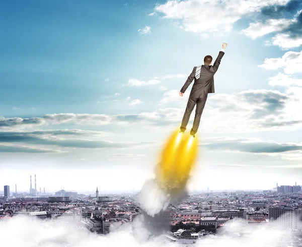 Businessman in suit flying