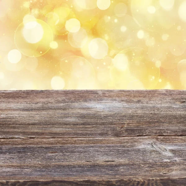 Wooden planks with golden bokeh background