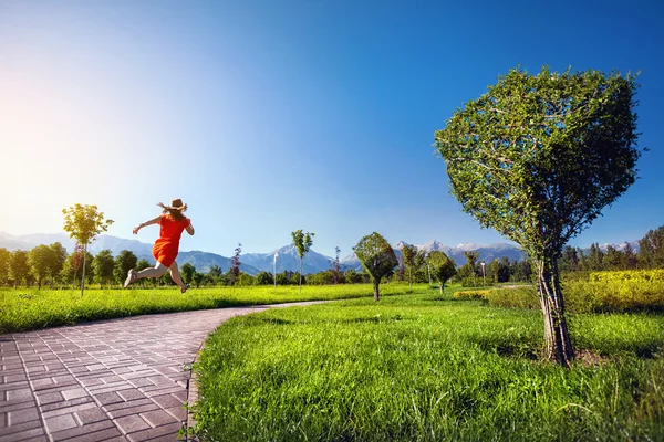 Woman running in surreal garden