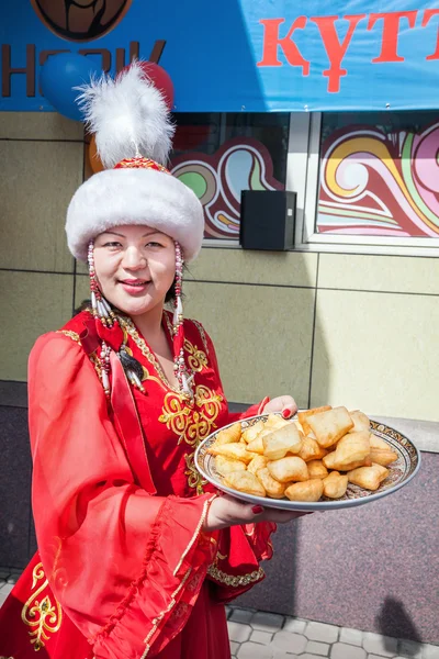Kazakh women holding baursaks