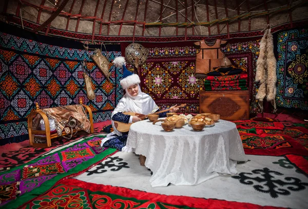 Kazakh women with dombra in the yurt