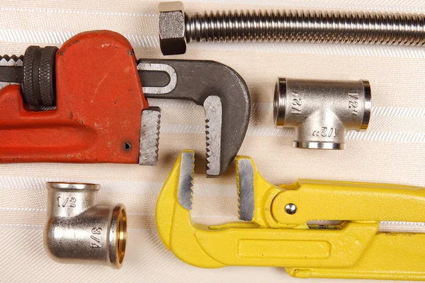Fitting and two adjustable wrenches for plumbing works