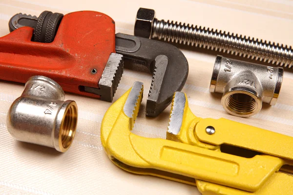 Fitting and two adjustable wrenches for plumbing works