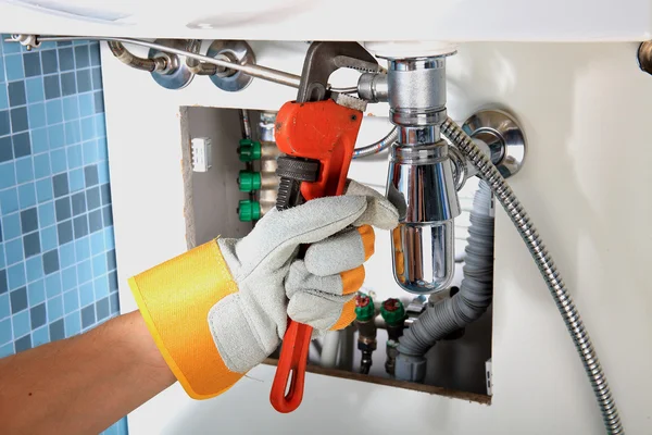 Repairing a pipe under a sink