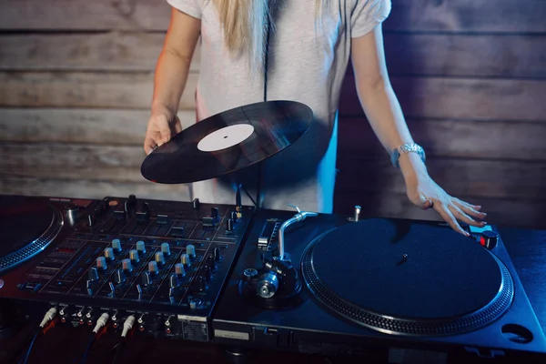 Cute dj woman having fun playing music at club party