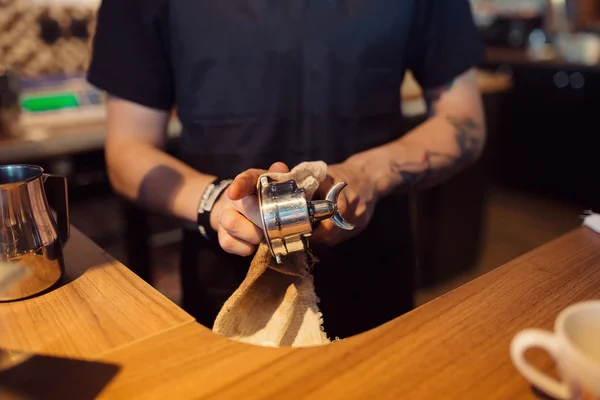 Barista at work in a coffee shop. Hands close up