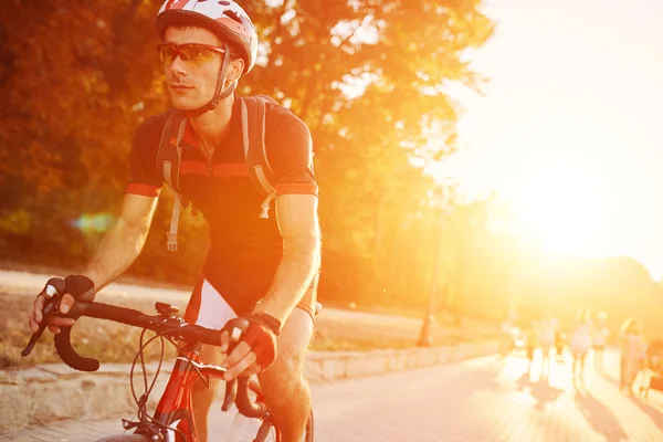 Young man are cycling road bike in the evening