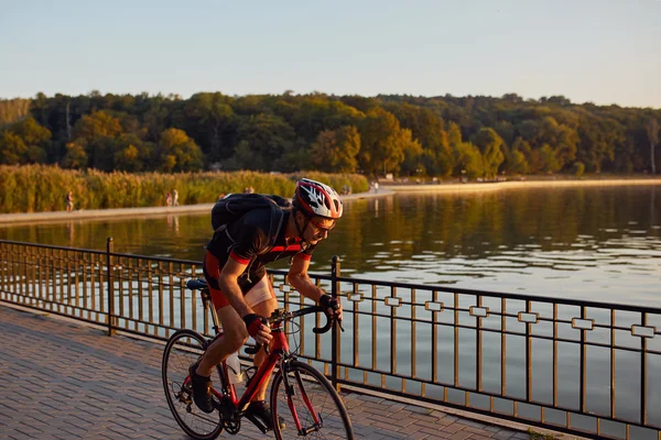 Young man are cycling road bike in the evening