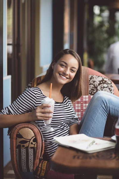 Young woman drinking milkshake