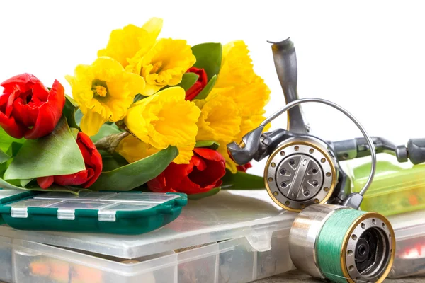 Fishing tackles with bouquet spring flowers