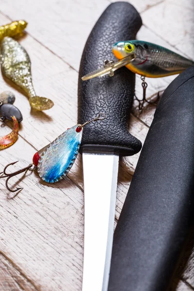 Closeup fishing baits and filet knife