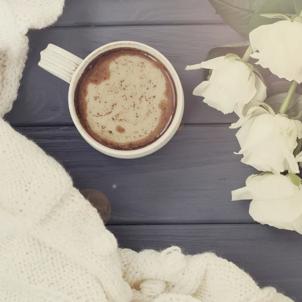 Cup of black coffee with milk or cream, white knitted plaid and
