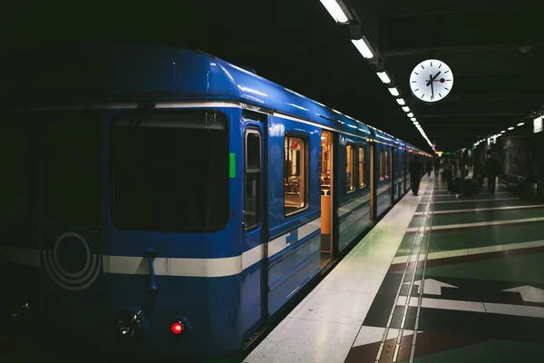 Train with open doors is a subway station