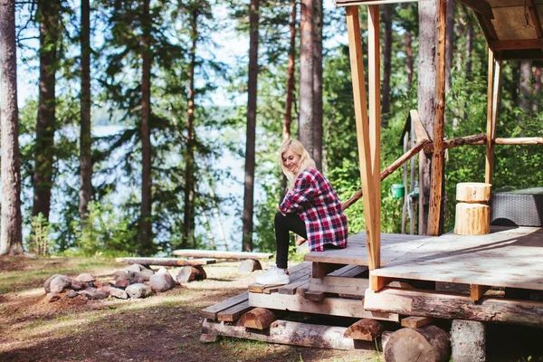 Girl sitting in a large tent in the woods